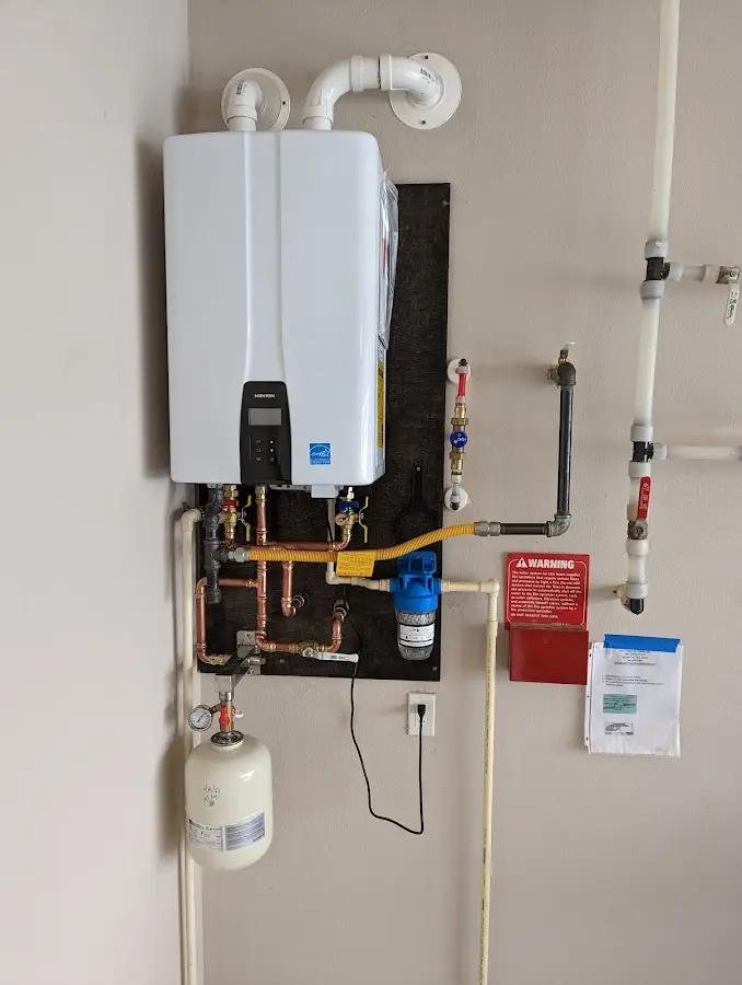 Professional plumber installing copper piping in a Parker home
